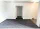 Spacious living area with gray carpet, bright white walls, and an open doorway to another room at 5056 Butler St, North Charleston, SC 29406