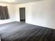 Bright living room with stylish gray carpet and large window with nice neutral colored curtains at 5056 Butler St, North Charleston, SC 29406