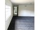 Spacious room with light walls, a large window, and a patterned carpet at 5056 Butler St, North Charleston, SC 29406
