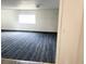 Spacious room with light walls, a large window, and a patterned carpet at 5056 Butler St, North Charleston, SC 29406