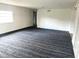 Spacious room with light walls, a large window, and a patterned carpet at 5056 Butler St, North Charleston, SC 29406