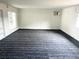 Spacious room with light walls, a large window, and a patterned carpet at 5056 Butler St, North Charleston, SC 29406