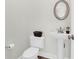 Powder room with pedestal sink, decorative mirror, and modern fixtures at 506 Cecilia Cove Dr, Charleston, SC 29412