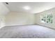 Bright bedroom featuring neutral carpet, large window offering natural light, and a spacious layout at 506 Cecilia Cove Dr, Charleston, SC 29412