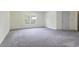 An inviting carpeted bedroom with natural light from the window provides a serene and spacious area at 506 Cecilia Cove Dr, Charleston, SC 29412