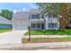Charming two-story home featuring a manicured lawn, driveway, and an attached two-car garage at 506 Cecilia Cove Dr, Charleston, SC 29412