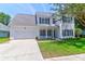Charming two-story home with a well-manicured lawn, attached garage, and beautiful curb appeal at 506 Cecilia Cove Dr, Charleston, SC 29412