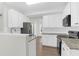 Bright kitchen features white cabinets, stainless steel appliances, and granite countertops at 506 Cecilia Cove Dr, Charleston, SC 29412