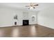 Spacious living room featuring hardwood floors, a cozy fireplace, and a ceiling fan for added comfort at 506 Cecilia Cove Dr, Charleston, SC 29412