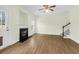 Bright living room with hardwood floors, fireplace, ceiling fan, and stairs to upper level at 506 Cecilia Cove Dr, Charleston, SC 29412