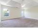 Spacious main bedroom with two windows, carpeted floor, and ceiling fan at 506 Cecilia Cove Dr, Charleston, SC 29412