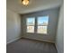 Bedroom featuring carpet floors and two large windows with neighborhood views at 5122 Double Eagle, Summerville, SC 29485