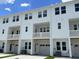 Stylish townhome showcases a clean white exterior, multiple balconies, and garage entry for convenient living at 5122 Double Eagle, Summerville, SC 29485