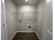 Well lit laundry room with dark vinyl floor, gray walls, and included wire rack at 5122 Double Eagle, Summerville, SC 29485