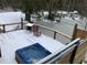 A backyard deck featuring a hot tub, furniture, and lights overlooking a river at 5219 Maybank Hwy, Wadmalaw Island, SC 29487