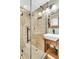 Bathroom features modern glass shower with dual shower heads and rustic wood vanity at 5219 Maybank Hwy, Wadmalaw Island, SC 29487
