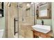 Bathroom features modern sink, glass shower, decorative mirror, and tiled walls at 5219 Maybank Hwy, Wadmalaw Island, SC 29487