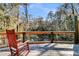 Wooden deck with a red rocking chair overlooking scenic water views at 5219 Maybank Hwy, Wadmalaw Island, SC 29487