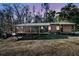 Charming home with a cozy porch, outdoor seating, and a welcoming exterior perfect for enjoying nature at 5219 Maybank Hwy, Wadmalaw Island, SC 29487