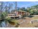 This house has a lovely deck overlooking a small pond surrounded by lush greenery at 5219 Maybank Hwy, Wadmalaw Island, SC 29487