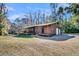 Charming home featuring a garage, an inviting porch, and lush trees in the background at 5219 Maybank Hwy, Wadmalaw Island, SC 29487