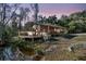 A home by the water has a spacious deck with outdoor seating and a grill, creating a relaxing outdoor space at 5219 Maybank Hwy, Wadmalaw Island, SC 29487