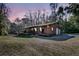 Attractive home with a classic design, well-lit exterior, inviting front porch, and a natural setting at 5219 Maybank Hwy, Wadmalaw Island, SC 29487