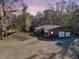 View of home featuring a metal roof, covered porch, outdoor lighting, and ample space for parking at 5219 Maybank Hwy, Wadmalaw Island, SC 29487
