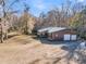 Rustic-style home featuring a metal roof, spacious porch, and large garage doors at 5219 Maybank Hwy, Wadmalaw Island, SC 29487