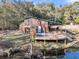 Charming cabin with a deck overlooking a serene pond, perfect for relaxation and enjoying nature at 5219 Maybank Hwy, Wadmalaw Island, SC 29487