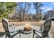 Outdoor fire pit with four chairs and a serene view of the surrounding landscape at 5219 Maybank Hwy, Wadmalaw Island, SC 29487