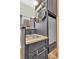 Kitchenette with stainless steel sink, granite countertop, mini-refrigerator and hanging cookware at 5219 Maybank Hwy, Wadmalaw Island, SC 29487