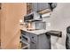 Compact kitchen features granite countertops, stainless steel appliances and custom gray cabinetry at 5219 Maybank Hwy, Wadmalaw Island, SC 29487