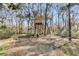 Well-maintained treehouse on wooded lot with fire pit and outdoor seating at 5219 Maybank Hwy, Wadmalaw Island, SC 29487