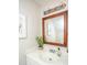 The well-lit bathroom offers a vanity with an integrated sink and an elegant framed mirror, creating a serene space at 607 Saint Charles Ct, Charleston, SC 29407