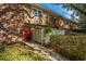 Charming townhome with brick and wood exterior and a vibrant red front door at 607 Saint Charles Ct, Charleston, SC 29407