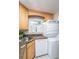 This laundry features a stacked washer and dryer, a stainless steel sink and beautiful wooden cabinets at 607 Saint Charles Ct, Charleston, SC 29407