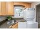 Convenient laundry area with stacked washer/dryer, sink, and ample counter space, perfect for tackling chores efficiently at 607 Saint Charles Ct, Charleston, SC 29407