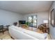 Bright living room with light walls, bamboo floors, and a sliding glass door at 607 Saint Charles Ct, Charleston, SC 29407