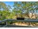 A tree-filled landscape surrounds a property with a view of the marshlands in the distance from the porch at 607 Saint Charles Ct, Charleston, SC 29407