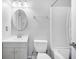 A minimalist bathroom features a vanity with a round mirror and a tub/shower combo at 7930 Timbercreek Ln # C, North Charleston, SC 29418