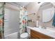 Bathroom featuring a tub/shower combo with a playful dinosaur-themed shower curtain and updated fixtures at 7930 Timbercreek Ln # C, North Charleston, SC 29418