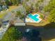 Aerial view of a community pool with a bathhouse set by a pond, perfect for outdoor fun at 7930 Timbercreek Ln # C, North Charleston, SC 29418