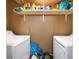 Organized laundry room with a laundry shelf, a front-load washer and dryer, and convenient storage solutions at 7930 Timbercreek Ln # C, North Charleston, SC 29418