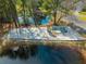 Aerial view of a neighborhood playground with a swing set and slide beside a tranquil pond at 7930 Timbercreek Ln # C, North Charleston, SC 29418