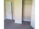 Neutral bedroom featuring neutral carpet, walls, and a closet with open doors at 7963 Weld St, North Charleston, SC 29418