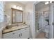 Bathroom featuring a vanity with granite counters, a large mirror, and a shower-tub combination at 8 Lagoon Villas, Isle of Palms, SC 29451