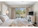 Bright bedroom with sliding glass doors to balcony with views of tropical trees at 8 Lagoon Villas, Isle of Palms, SC 29451