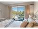 Inviting bedroom with access to a private balcony featuring views of lush greenery at 8 Lagoon Villas, Isle of Palms, SC 29451