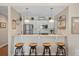 This bright kitchen is designed with stainless appliances, white cabinetry, and barstool seating at 8 Lagoon Villas, Isle of Palms, SC 29451